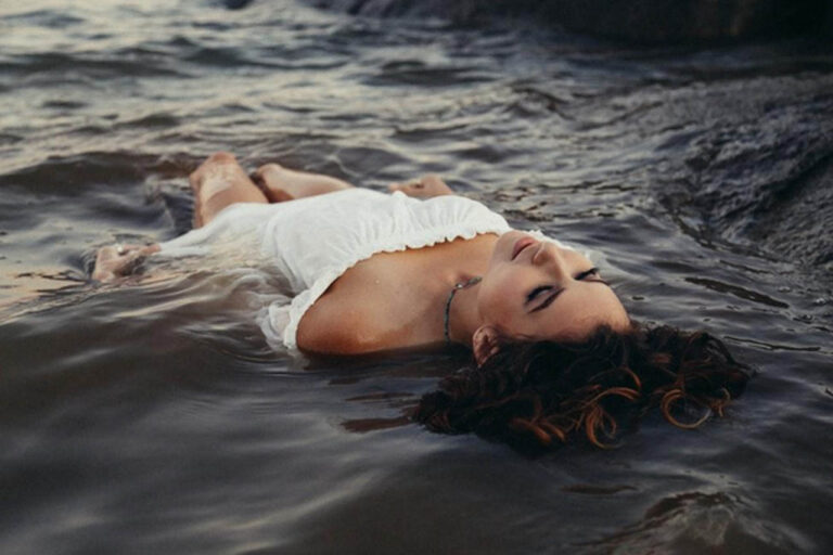 woman relaxing floating in water
